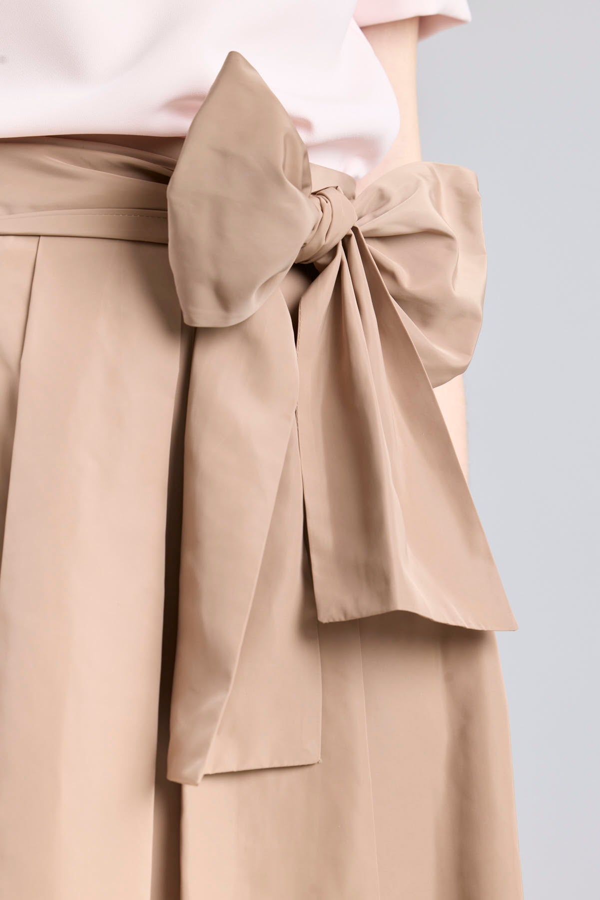 Structured camel midi skirt with volume and waist bow detail by The Extreme Collection.
