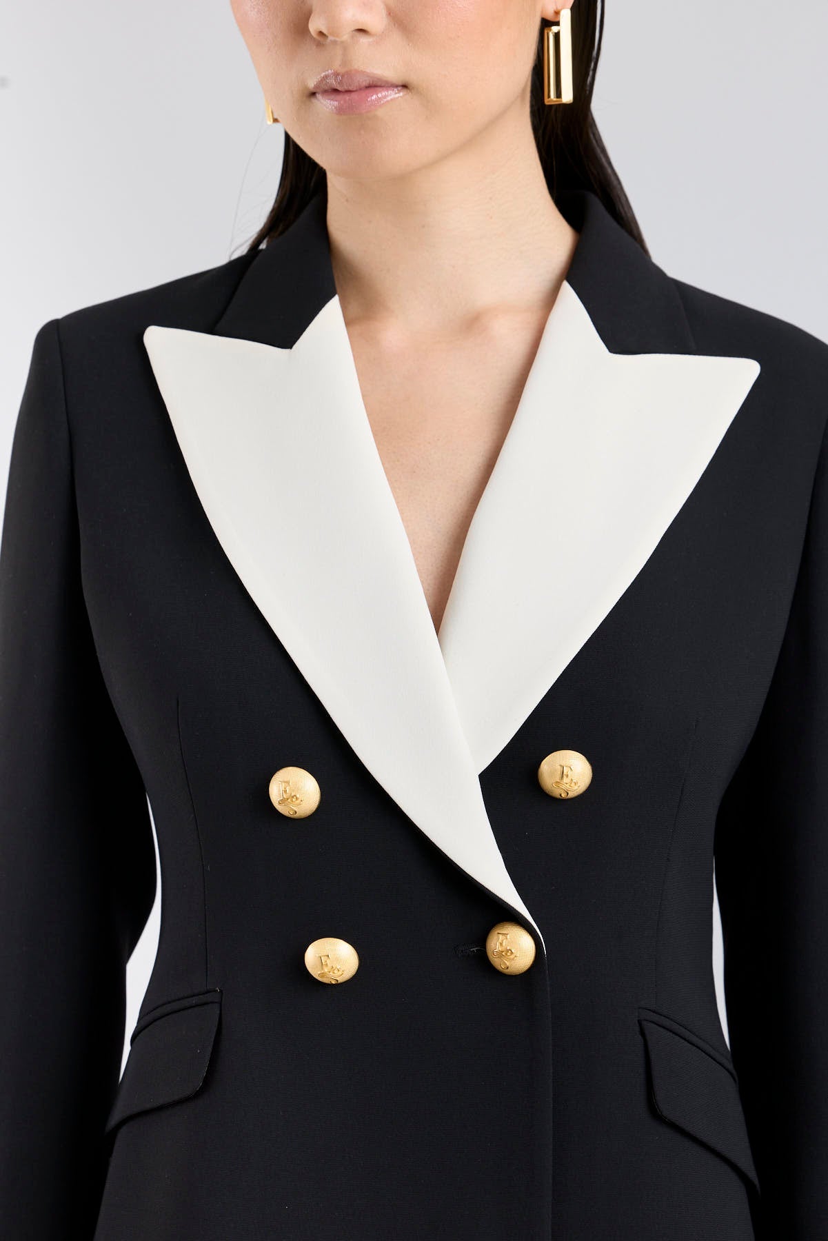 Women’s Iconic Code 01 designer double-breasted blazer in black with optical white peak lapels and gold heraldic buttons.