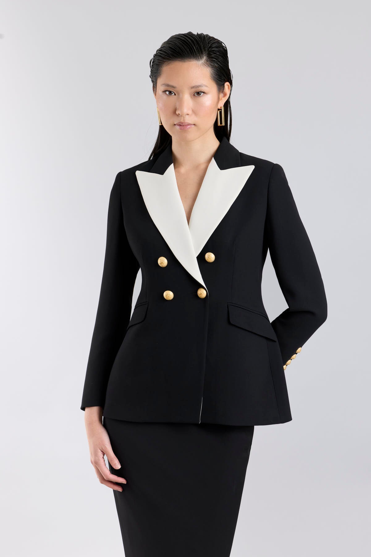 Women’s Iconic Code 01 designer double-breasted blazer in black with optical white peak lapels and gold heraldic buttons.