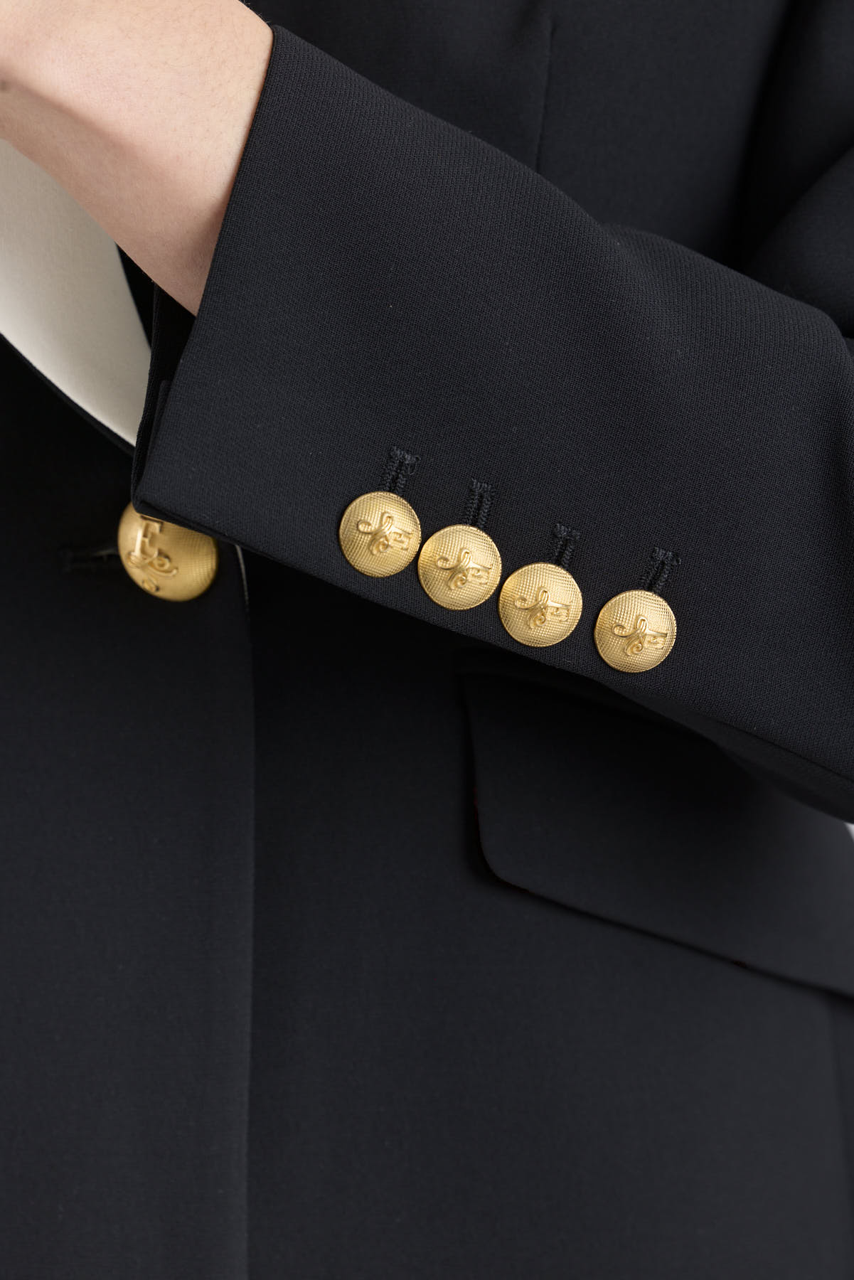 Women’s Iconic Code 01 designer double-breasted blazer in black with optical white peak lapels and gold heraldic buttons.