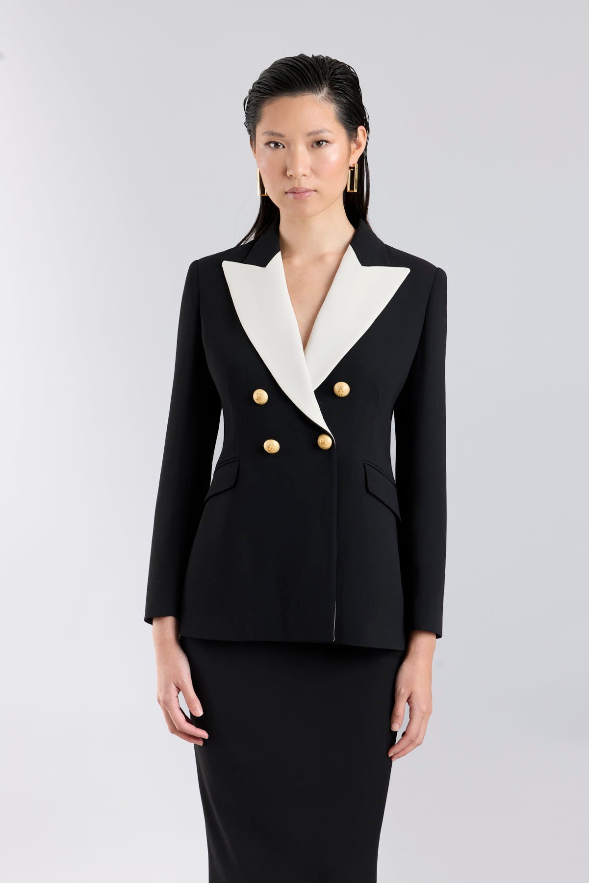 Women’s Iconic Code 01 designer double-breasted blazer in black with optical white peak lapels and gold heraldic buttons.